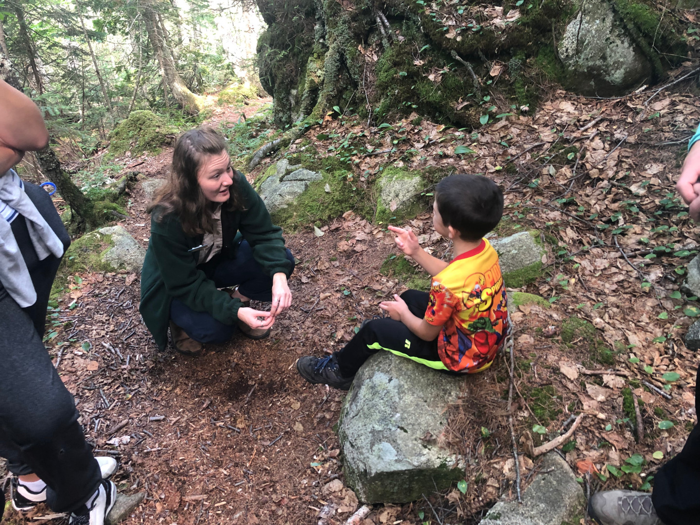 Staff talking to visitors on a trail.