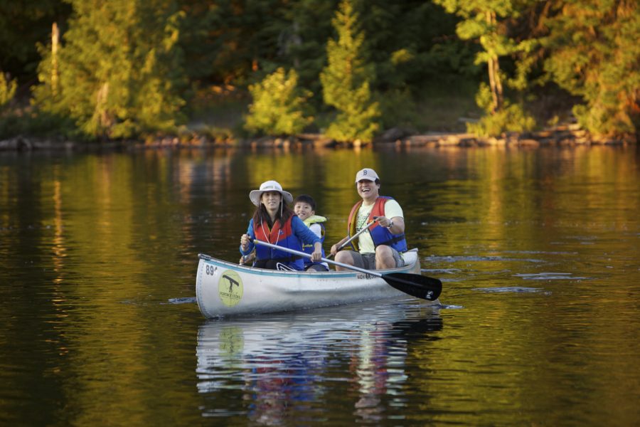 Family in a canoe on the lake at Algonquin