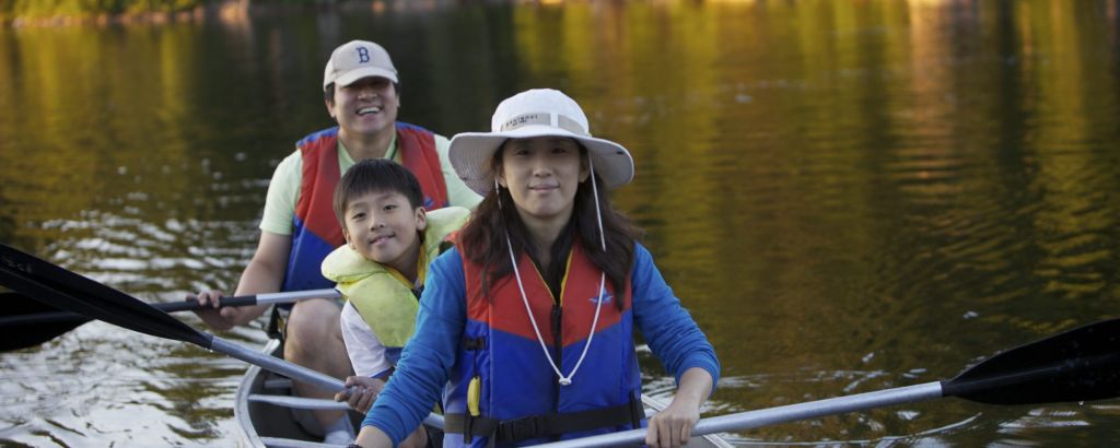 Family canoeing on a lake