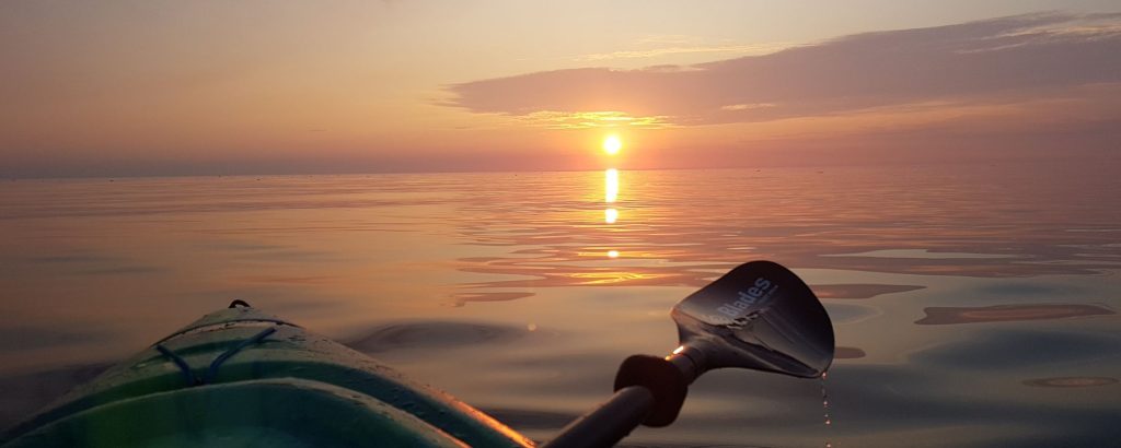 kayak on lake at sunset