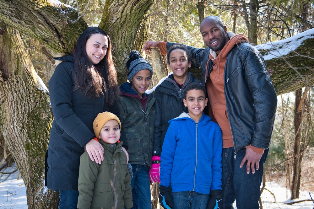 family in front of tree