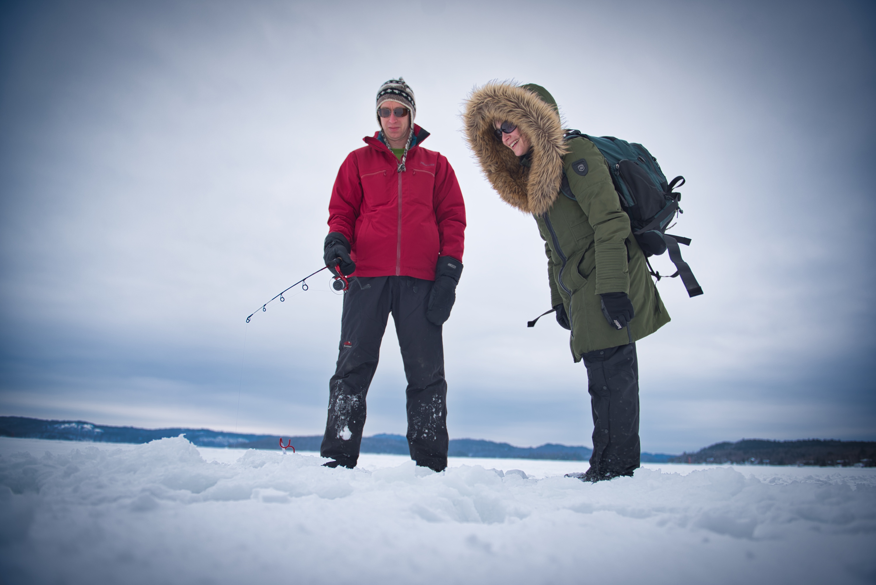 A couple tries ice-fishing