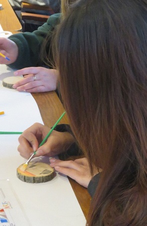 person painting tree cookie