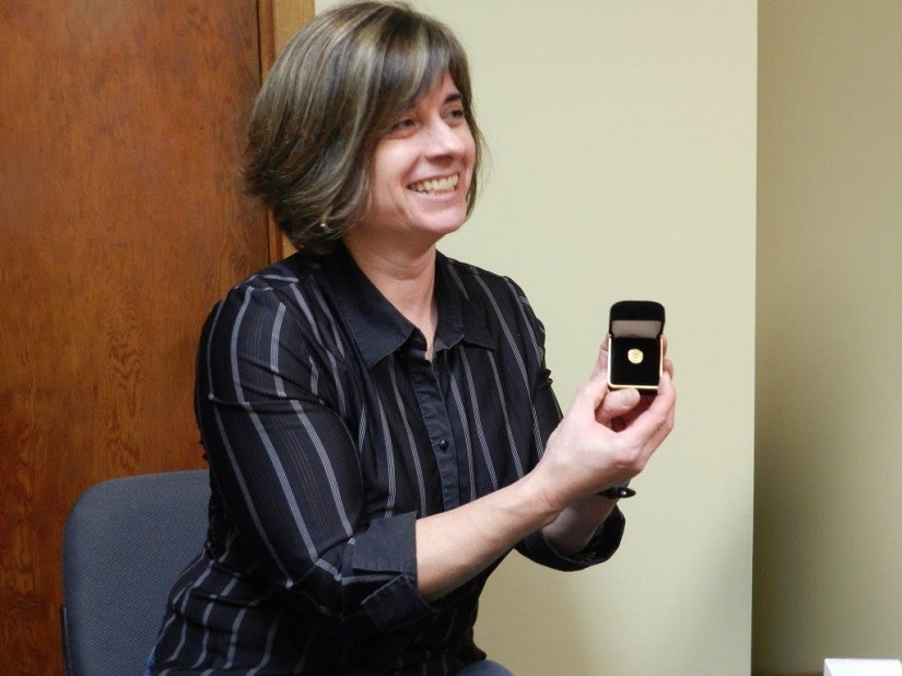 Woman holding a pin in a box