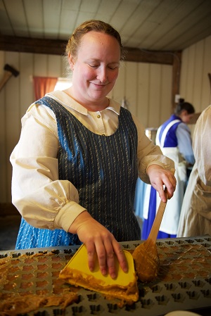 Maple sugar being spread across a silicone mat