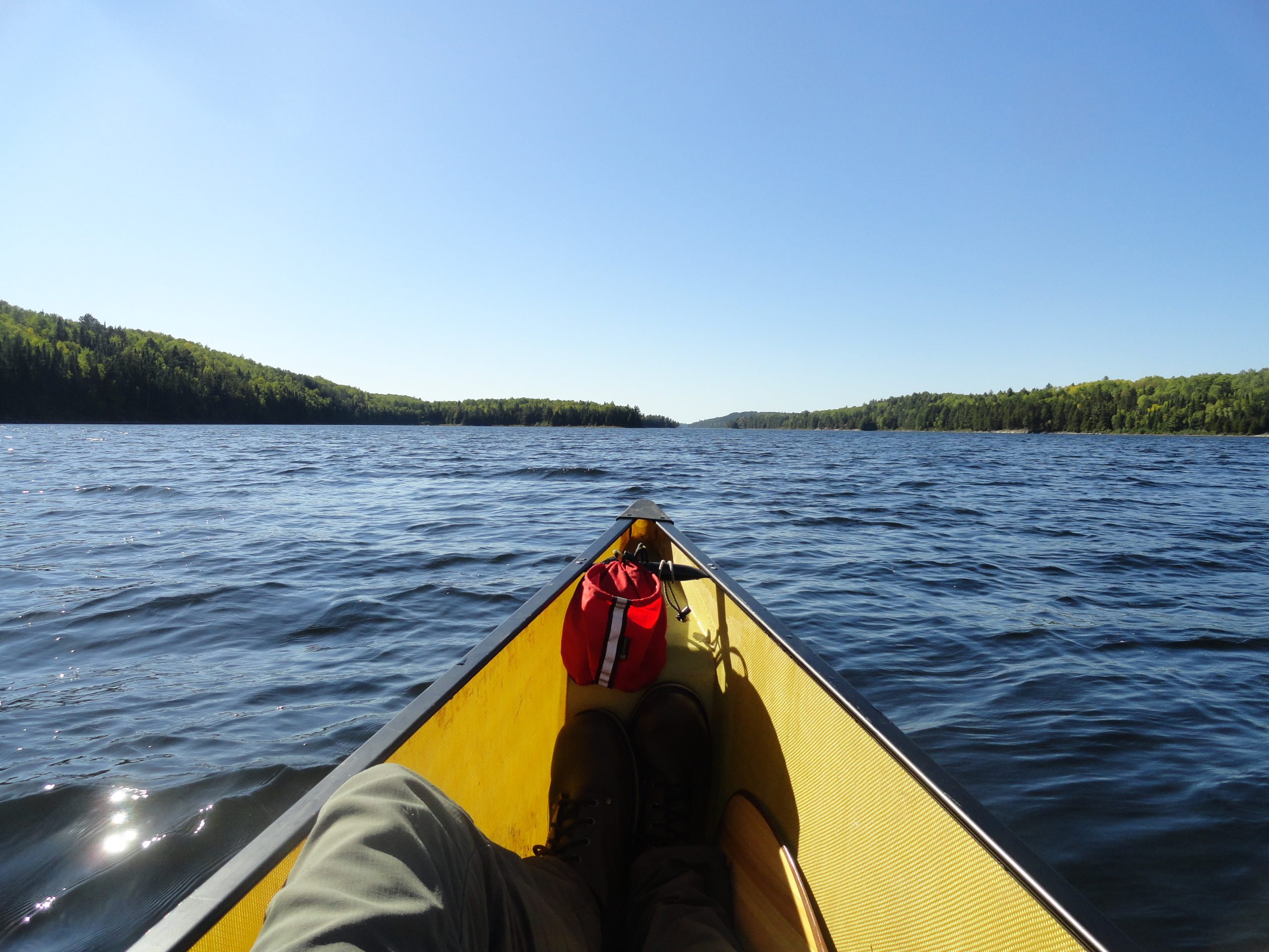 View from the bow of a canoe on a lake
