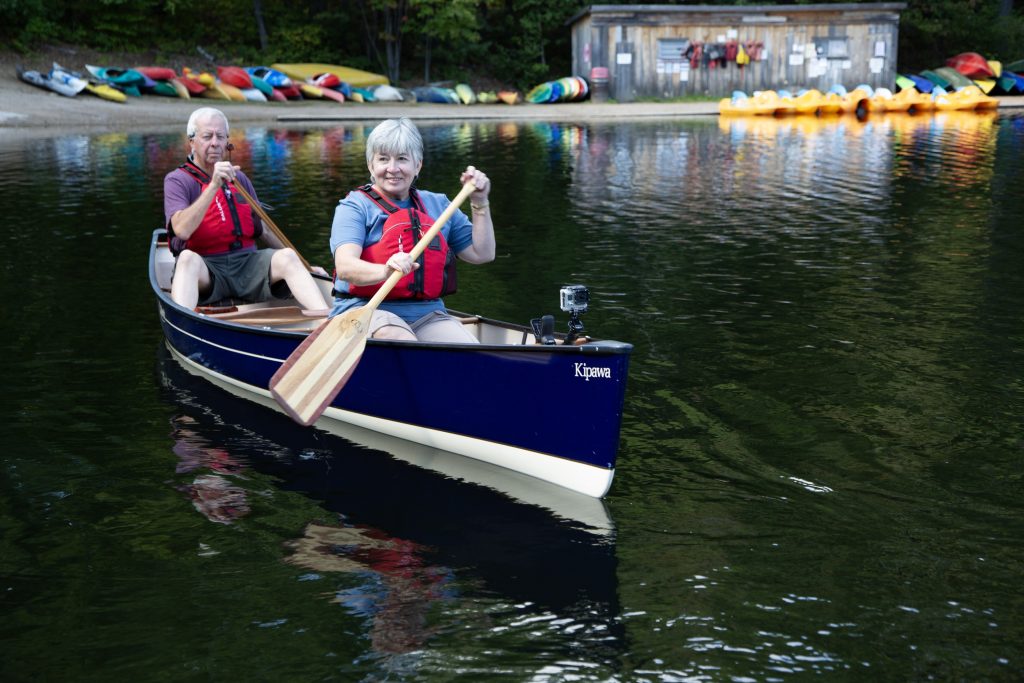senior couple canoeing in lake