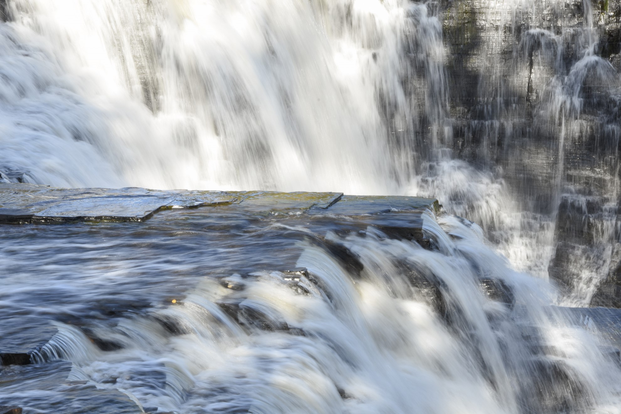 Water falling over brown rocks