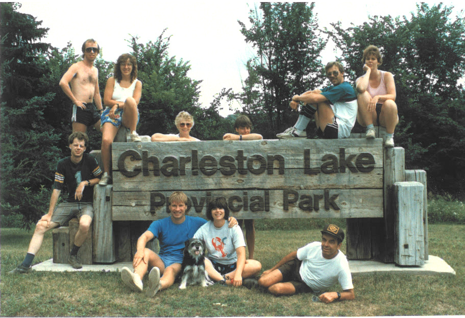 vintage photo of staff sitting near park sign