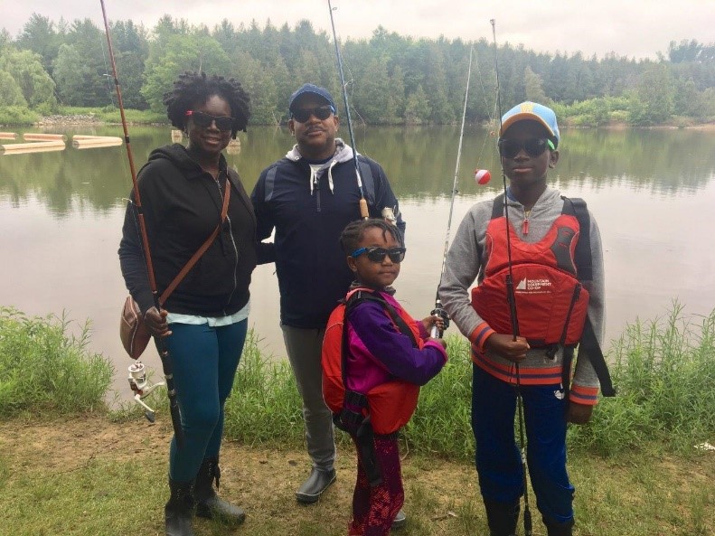 family of four fishing from shore