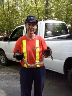 Eddie holding GM1 (a threatened Eastern foxsnake that was named after Eddie’s radio call sign). 