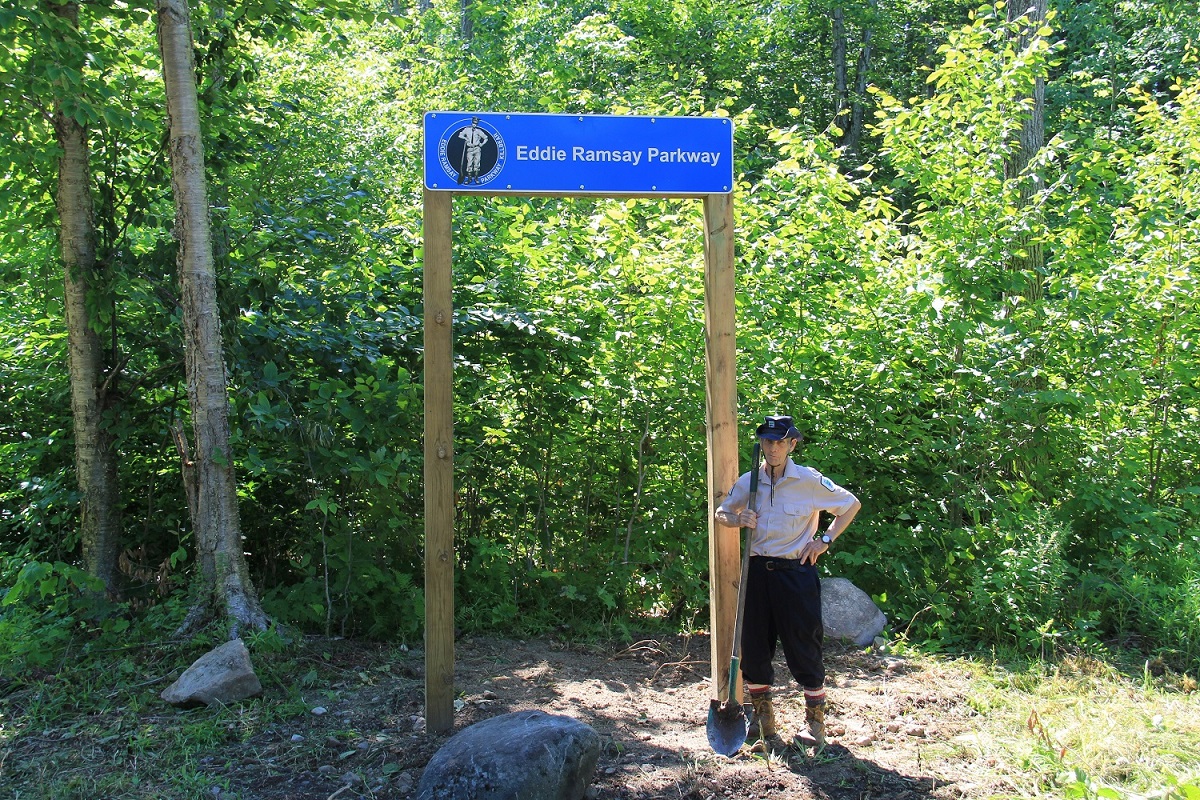 Eddie standing next to a sign for the parkway