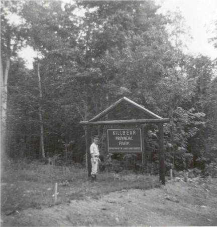 person standing near killbear sign