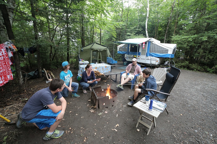 family on campsite with trailer