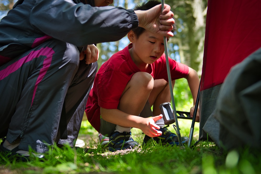 family setting up tent