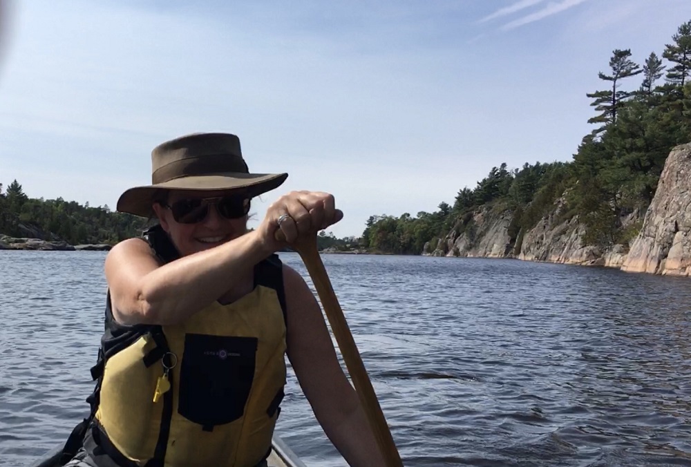 staff paddling canoe