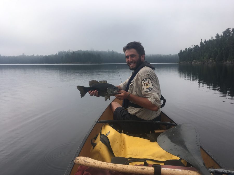 park ranger holding bass