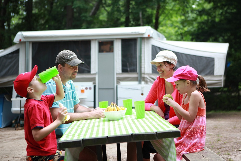 family in front of trailer