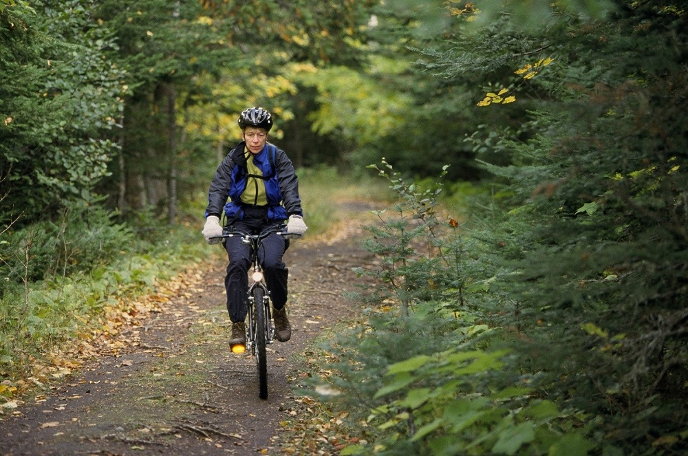 person biking on trail