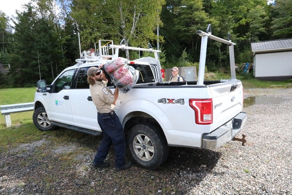 staff hauling garbage out of truck