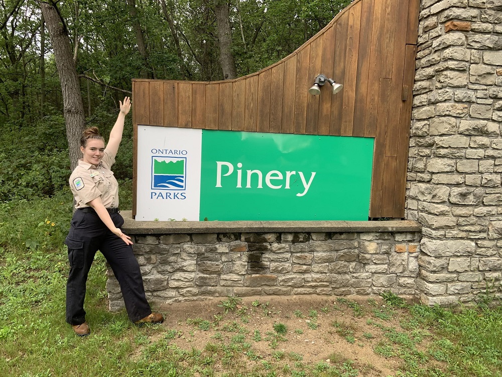 staff in front of pinery sign