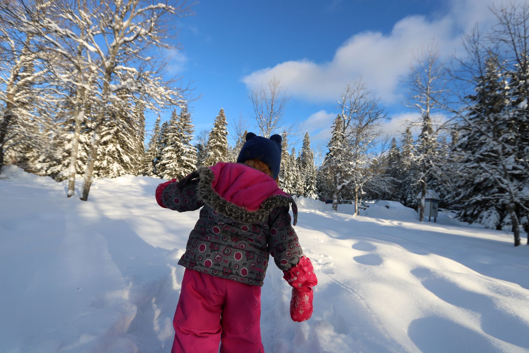 A kid playing outside in the snow