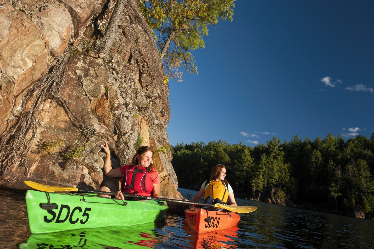 Two people in kayaks on the water. 