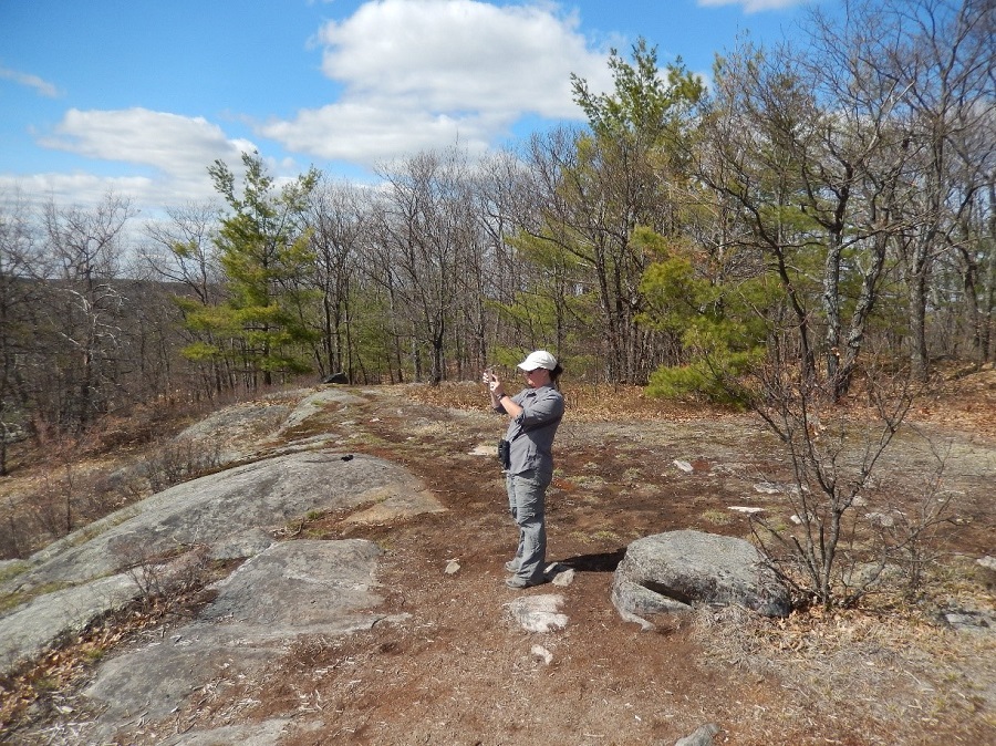 Person taking a photo on a trail.