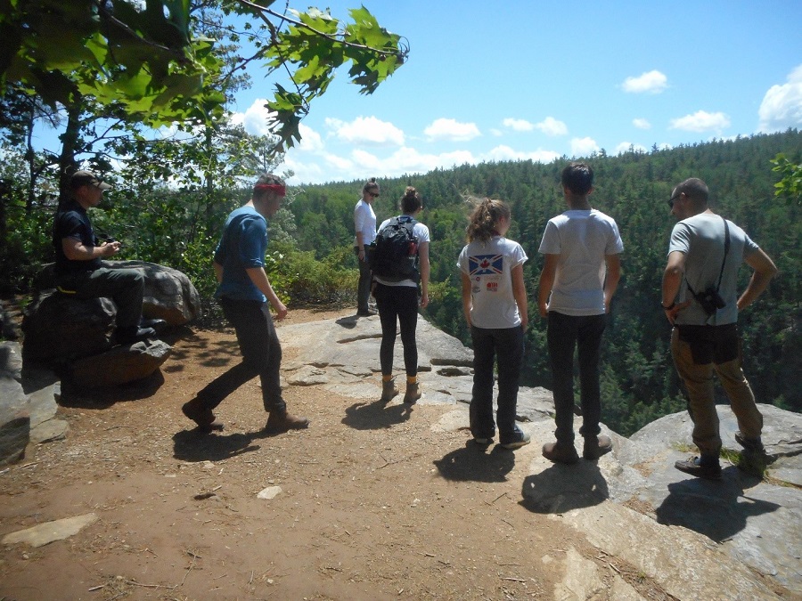 Ontario Parks staff looking over a cliff.