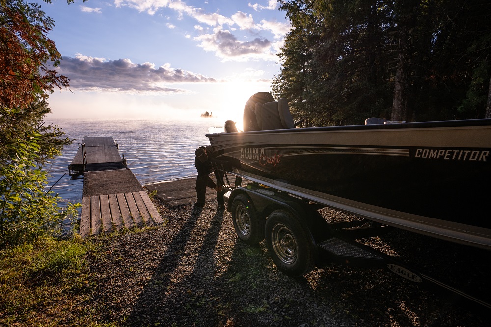 truck putting a fishing boat in the water at the boat launch