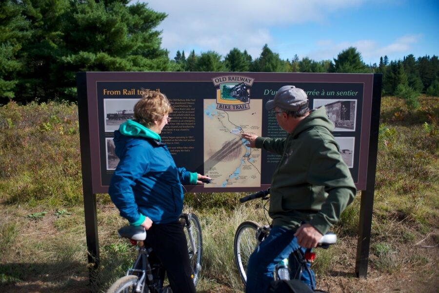 people looking at trail sign