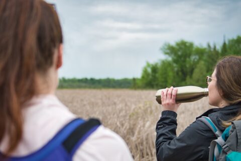 Woman drinking water on a trail.