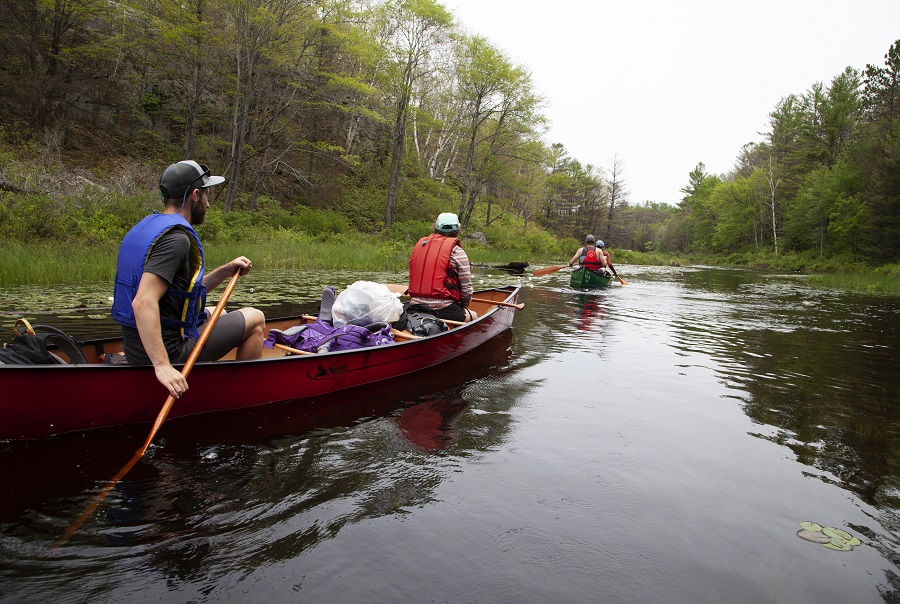 A couple canoeing in the backcountry and bringing their garbage out.