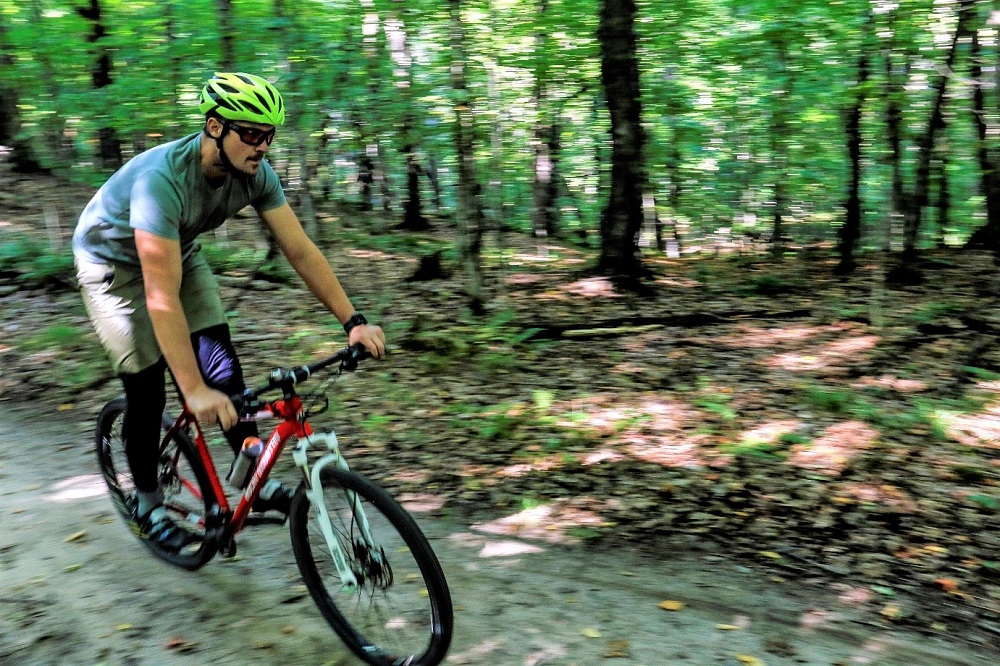 person biking through woods