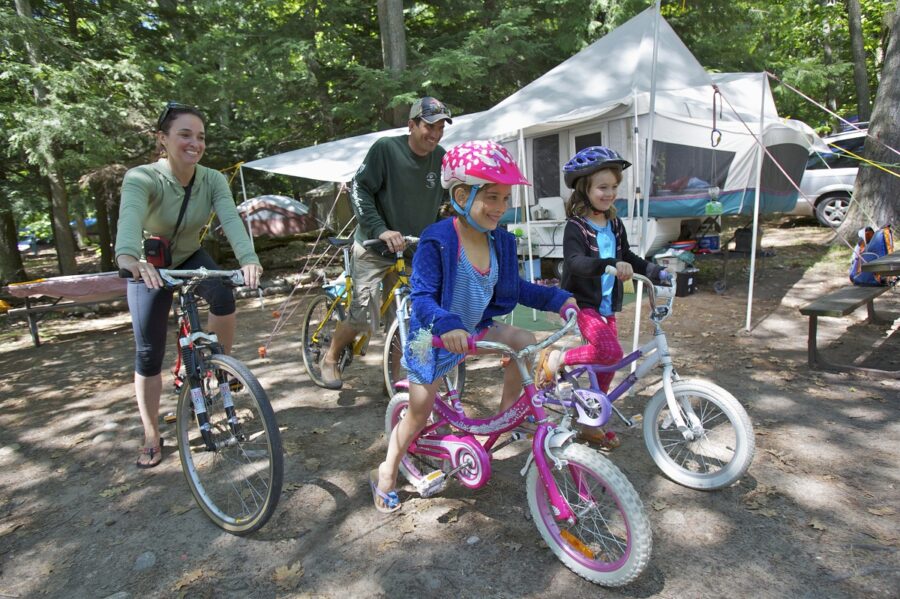 family biking on park road