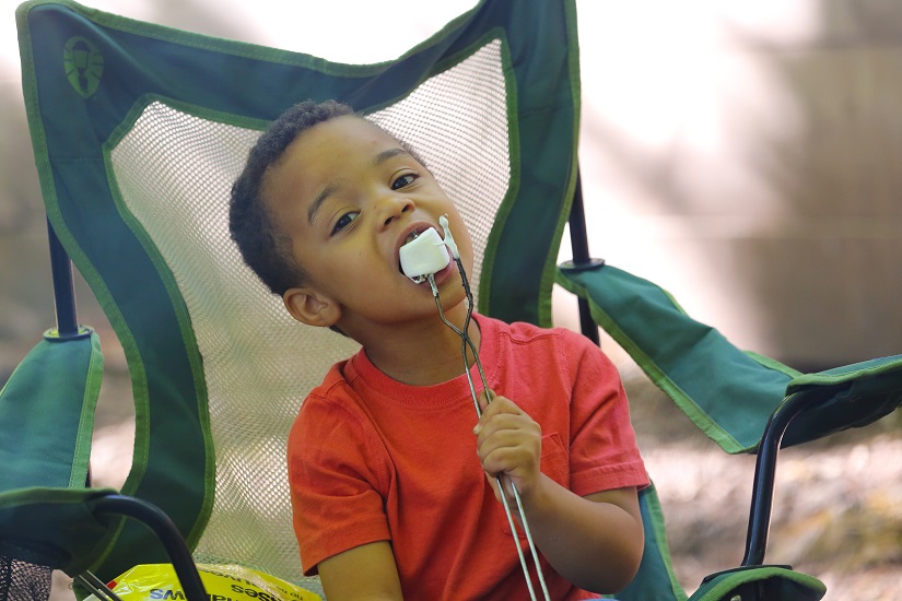 Child eating marshmallow.