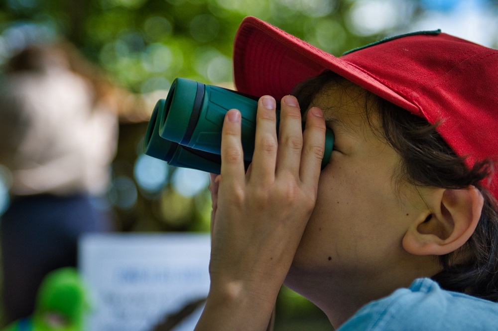 child looking through binoculars