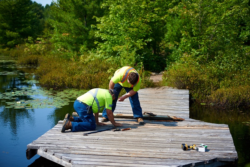 Maintenance worker fixing dock.