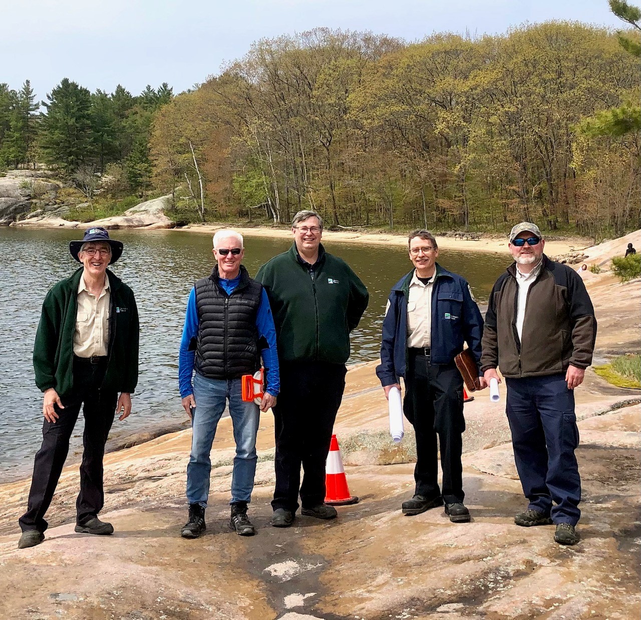 staff standing on shoreline