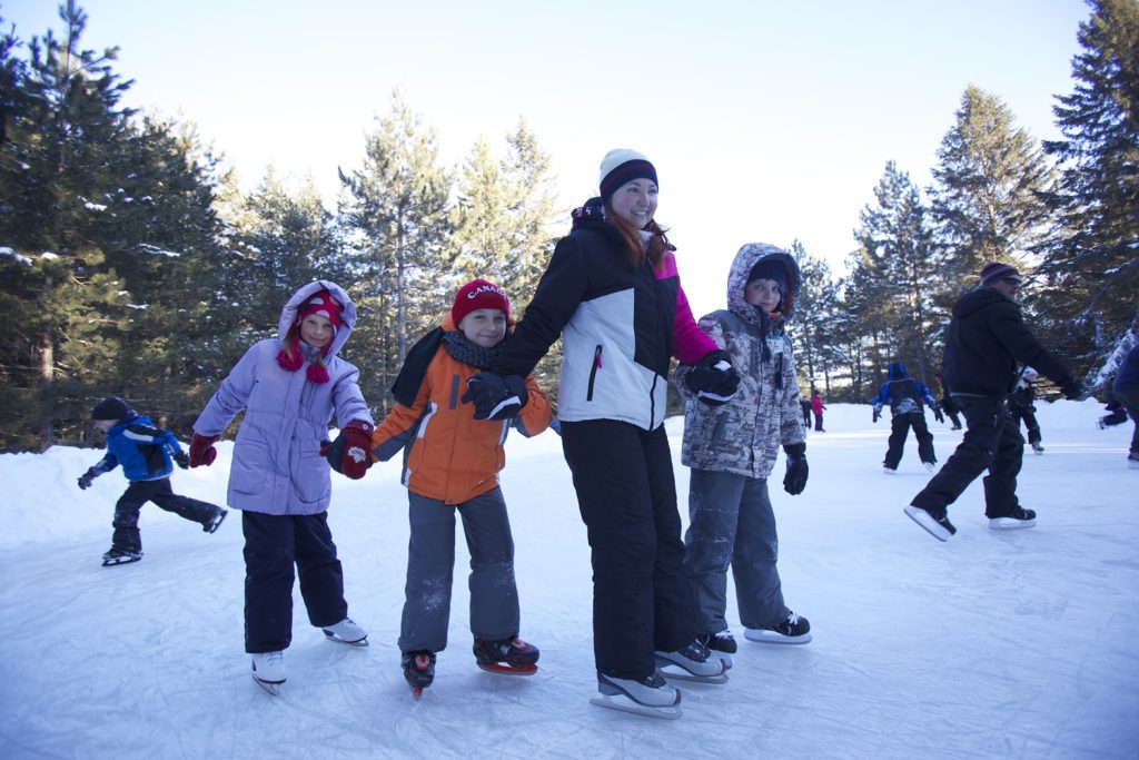 family skating while holding hands