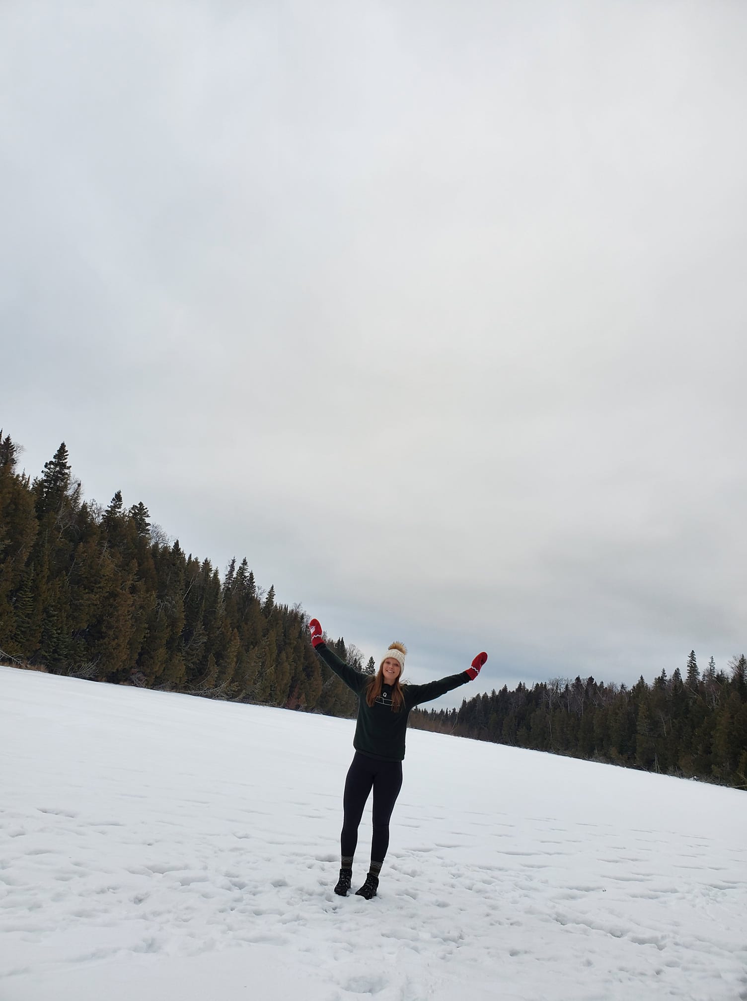 woman standing on frozen lake