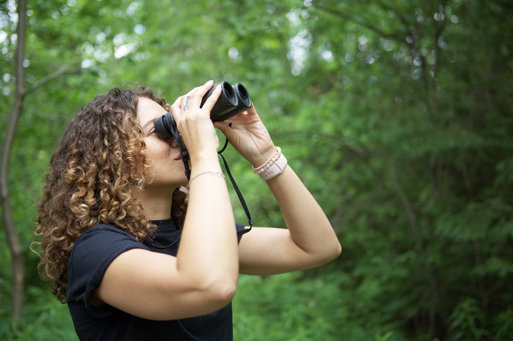 woman looking through binoculars