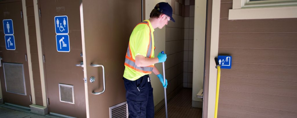staff cleaning washroom
