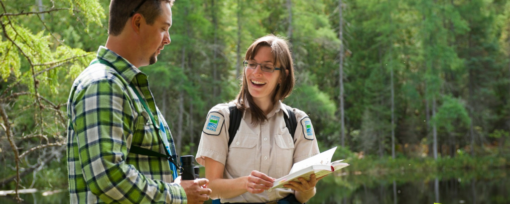 staff holding clipboard with visitor