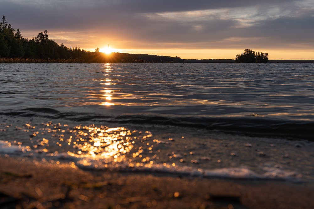 sun setting over lake