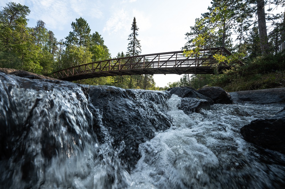 Landscape of bridge overtop of waterfall