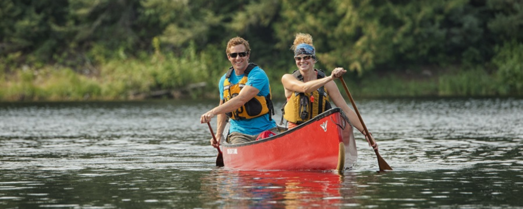Two people paddling a red canoe in Wabakimi Provincial Park