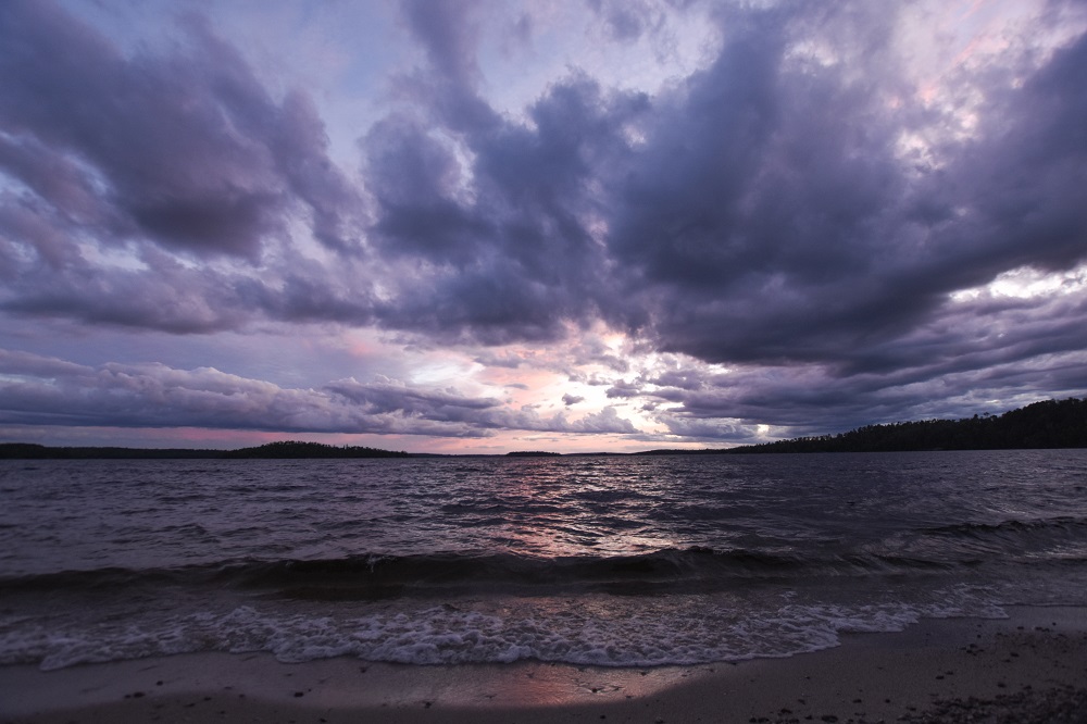 Purple sunset over waves