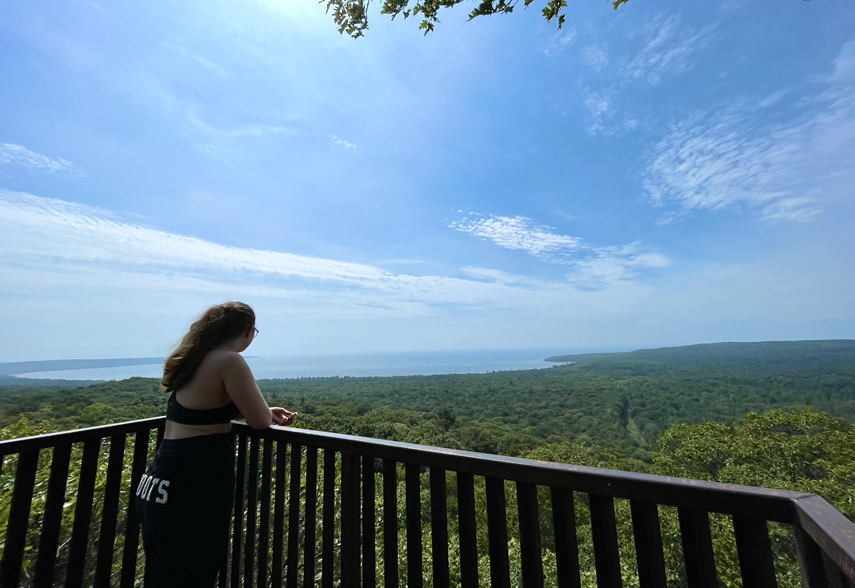 person looking out at trail