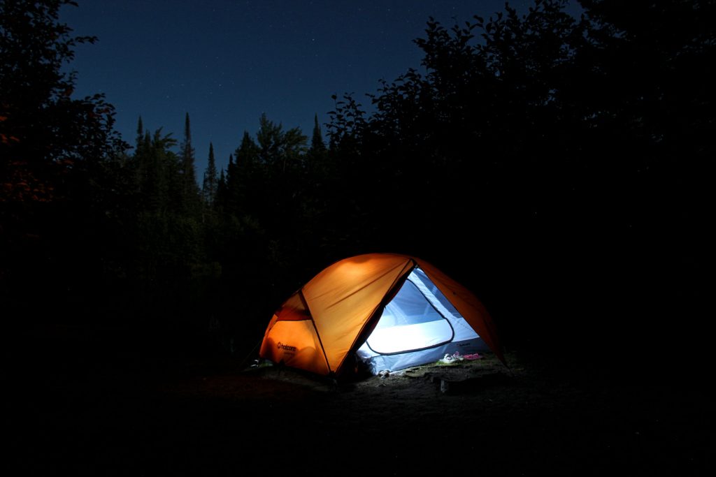 lit tent on campsite